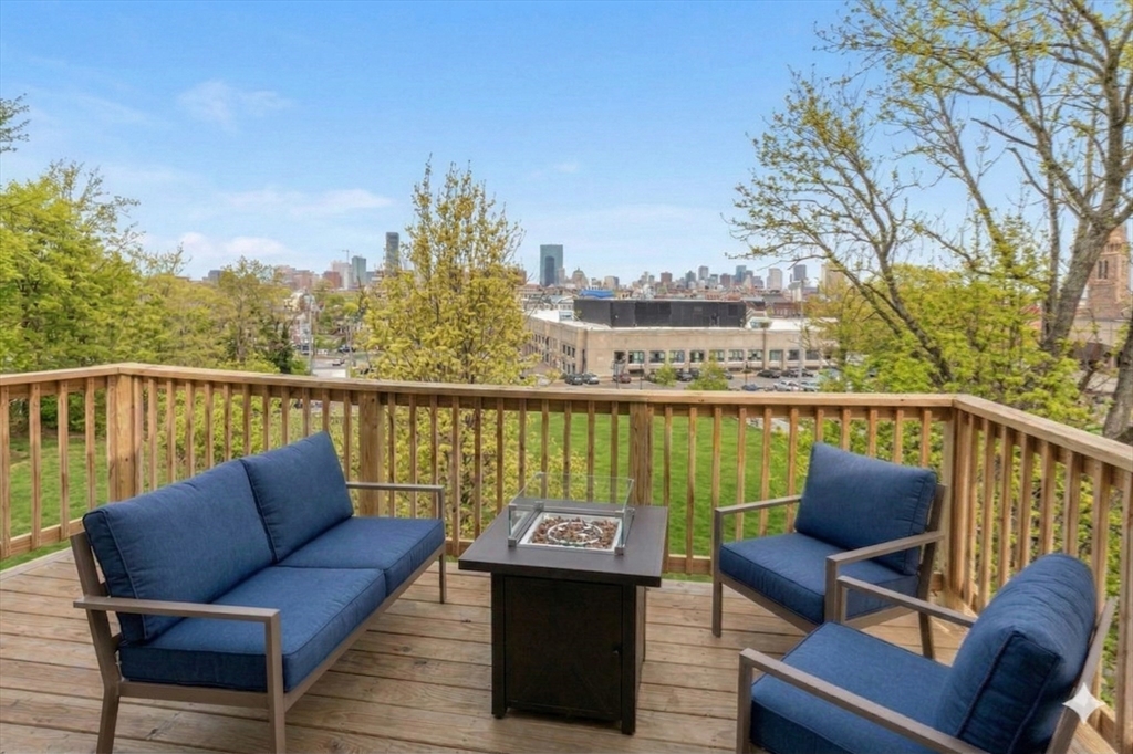 27 St James Street Boston, MA 02119 - Photo 20 of 26 a view of a balcony with wooden floor and outdoor seating