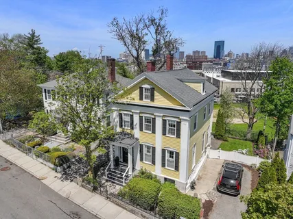 a aerial view of a house with a yard and potted plants