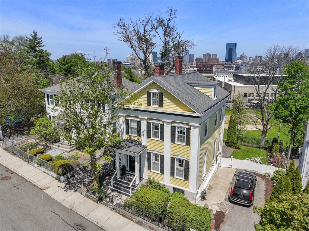 27 St James Street Boston, MA 02119 - Photo 2 of 26 a aerial view of a house with a yard and potted plants