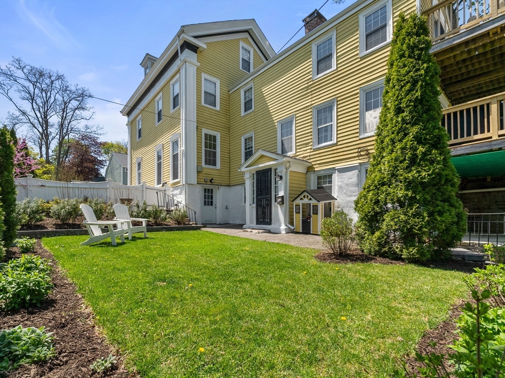 27 St James Street Boston, MA 02119 - Photo 3 of 26 a front view of a house with a garden