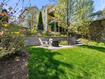 a front view of house with a garden