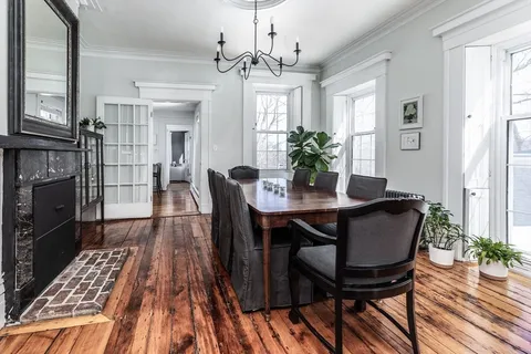 a view of a dining room with furniture and wooden floor