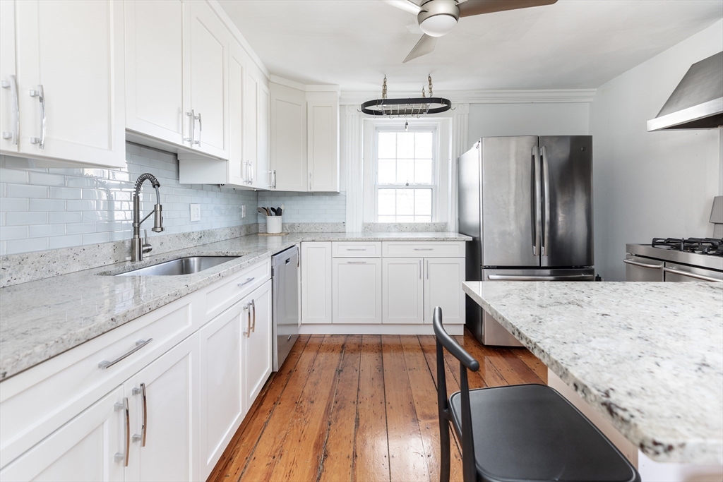 27 St James Street Boston, MA 02119 - Photo 10 of 26 a kitchen with a sink stove and refrigerator