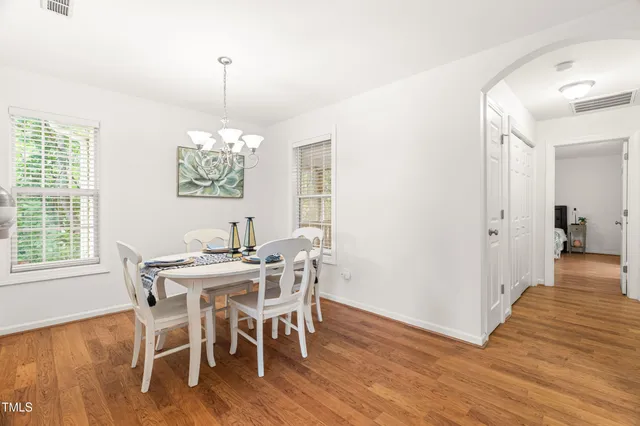 a view of a dining room with furniture wooden floor and chandelier