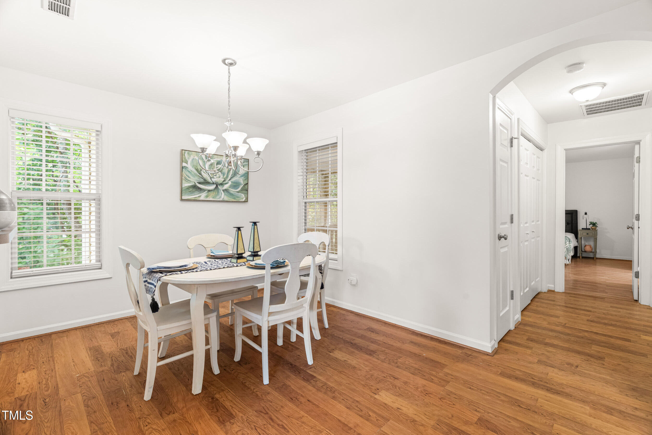 2221 Mountain Mist Court, Unit 201 Raleigh, NC 27603 - Photo 13 of 26 a view of a dining room with furniture window and wooden floor