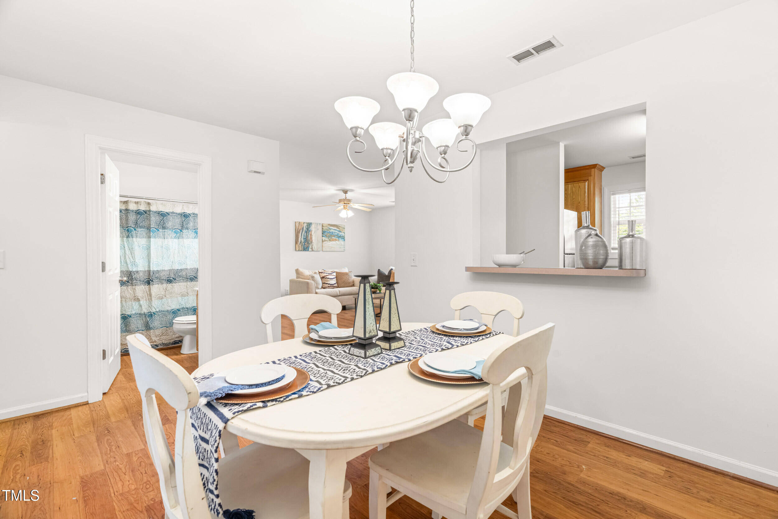 2221 Mountain Mist Court, Unit 201 Raleigh, NC 27603 - Photo 14 of 26 a view of a dining room with furniture wooden floor and chandelier