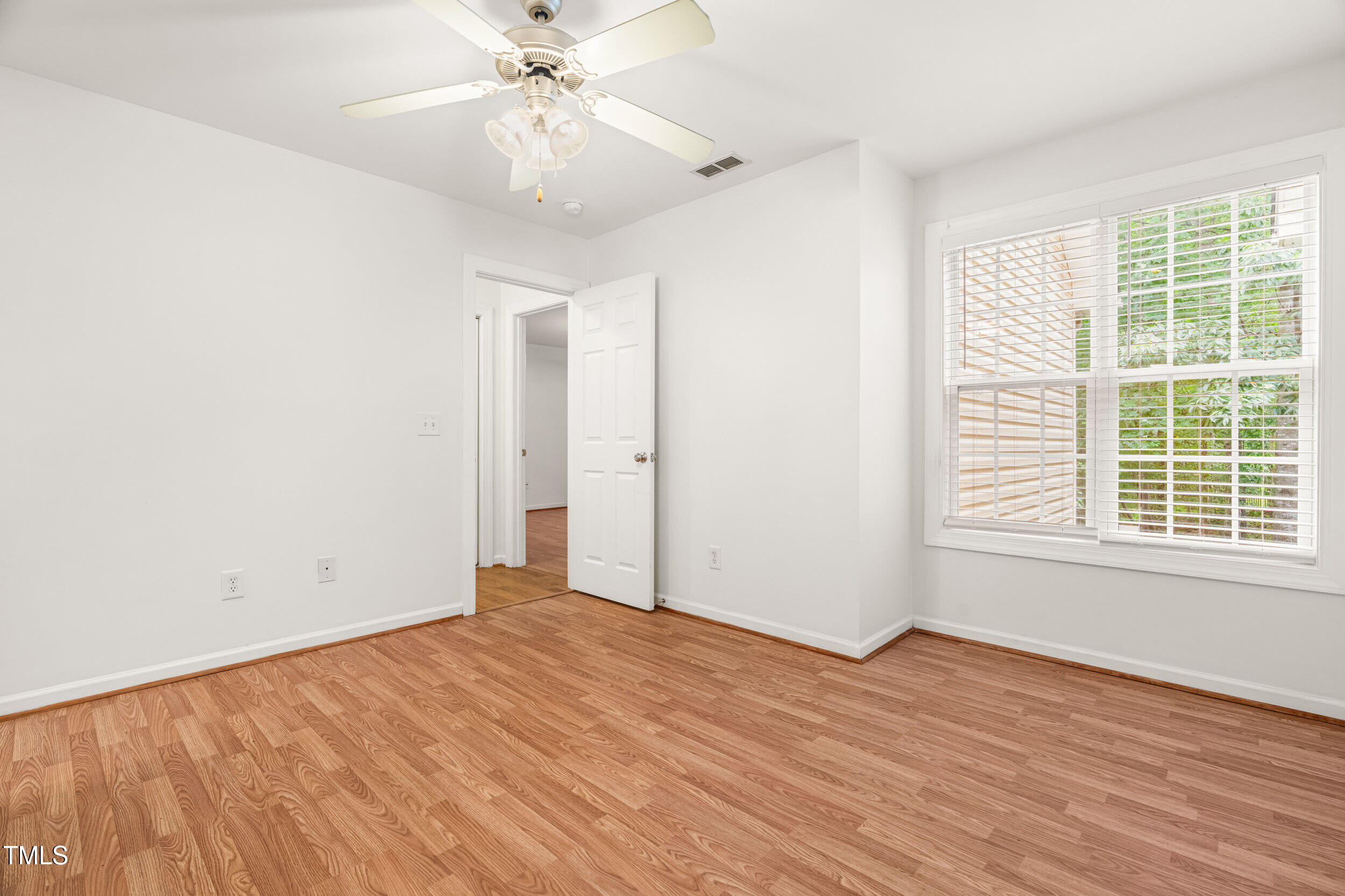 2221 Mountain Mist Court, Unit 201 Raleigh, NC 27603 - Photo 17 of 26 a view of an empty room with wooden floor and a window