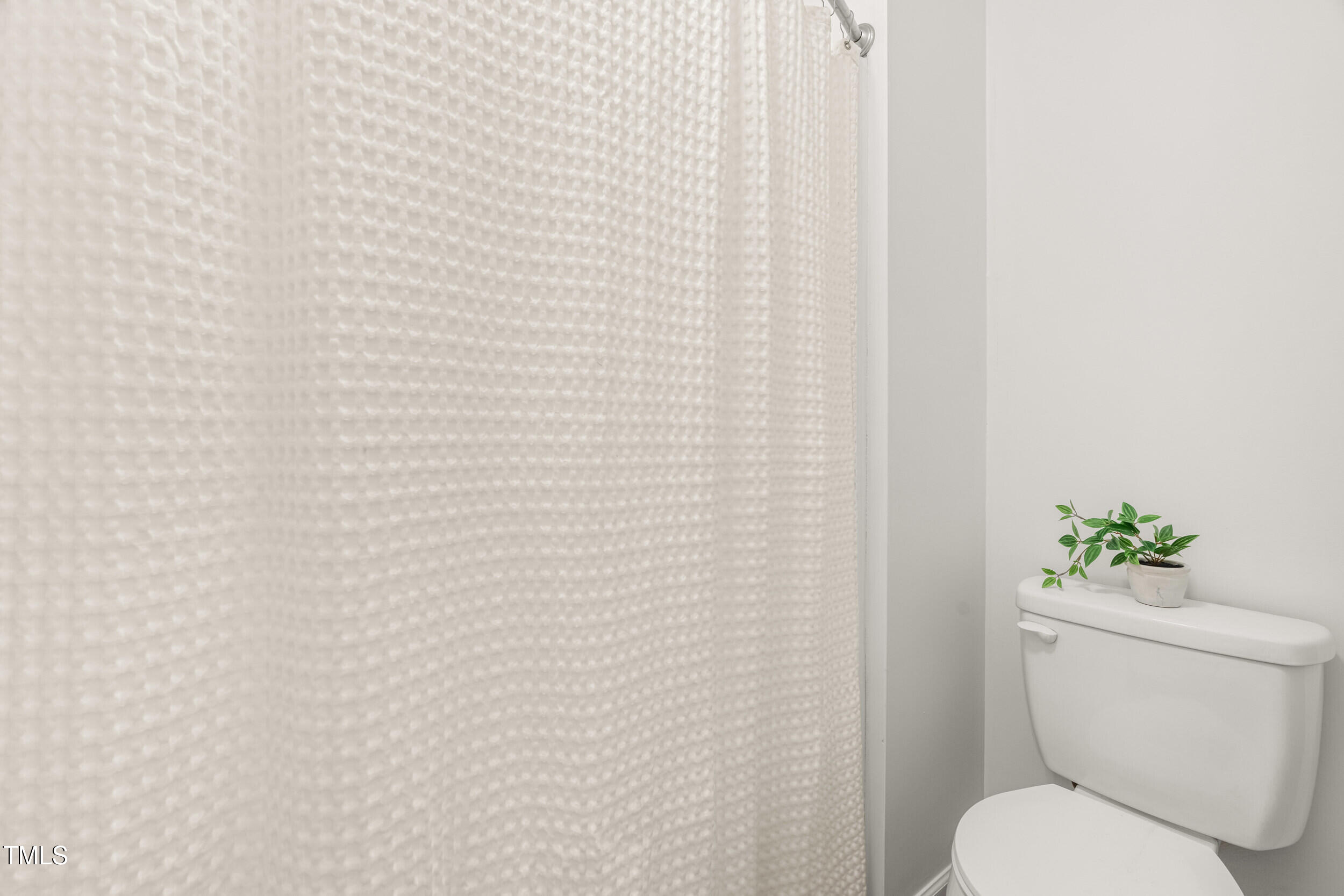 2221 Mountain Mist Court, Unit 201 Raleigh, NC 27603 - Photo 22 of 26 a white toilet sitting next to a white wall