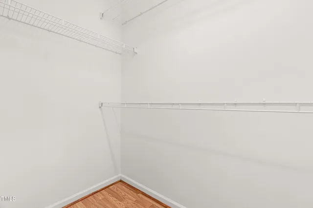 a view of hallway with wooden floor