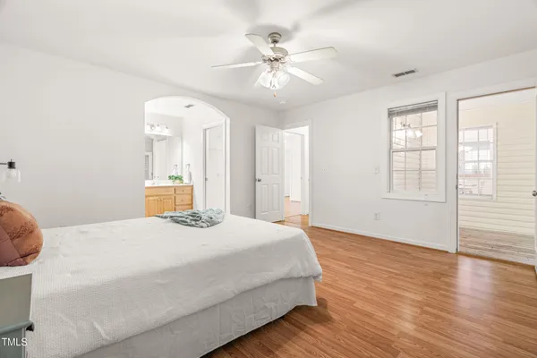 a bedroom with a large bed and a chandelier