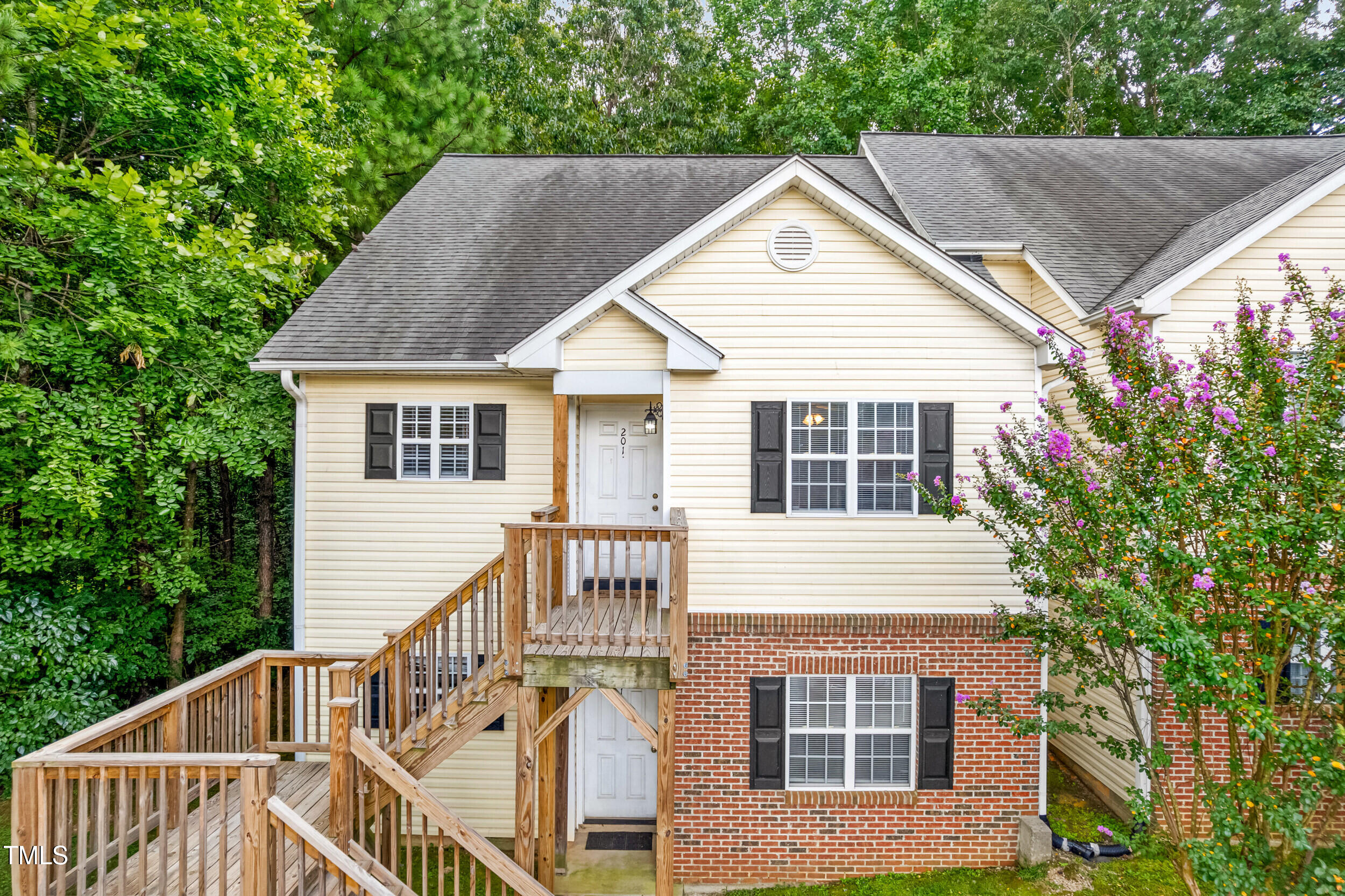 2221 Mountain Mist Court, Unit 201 Raleigh, NC 27603 - Photo 6 of 26 a view of a house with a yard and potted plants