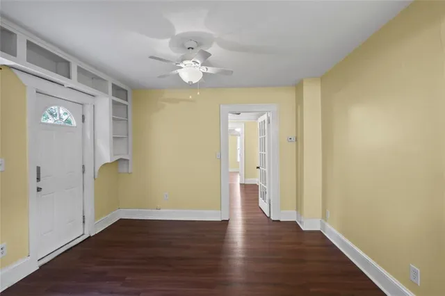 a view of an empty room with wooden floor