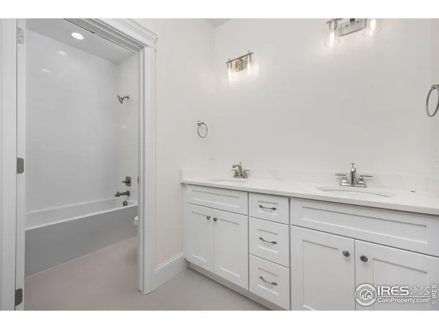a spacious bathroom with a tub sink and mirror
