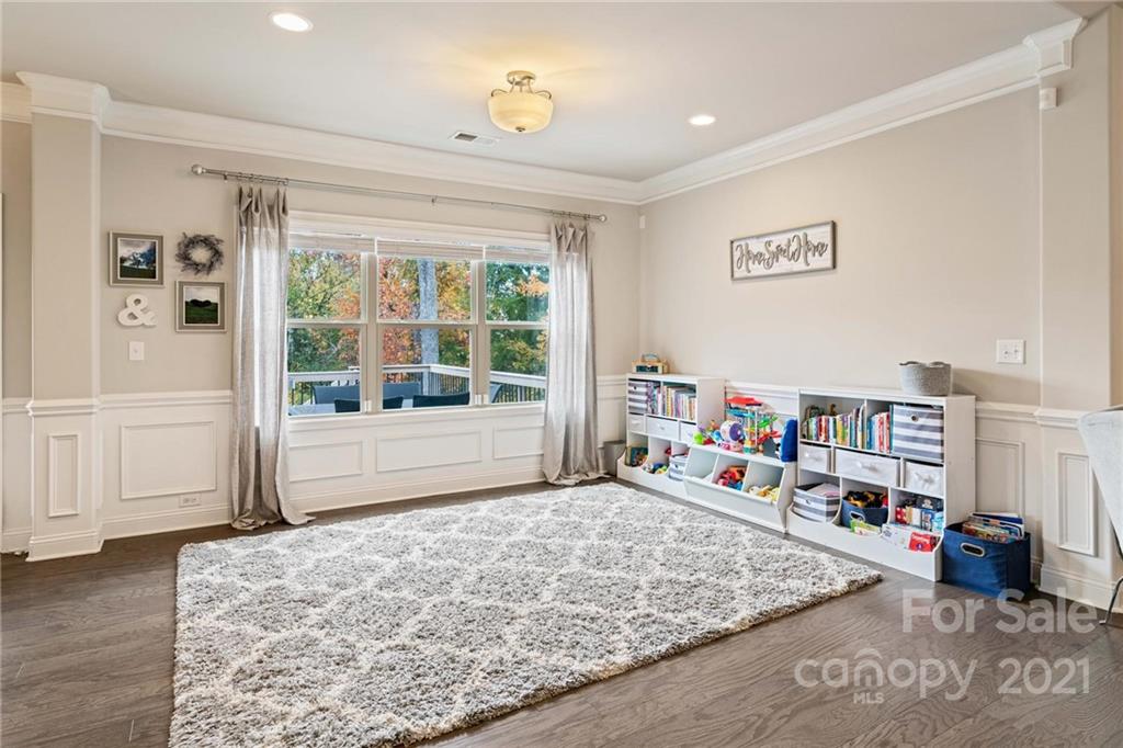 16024 Loch Raven Road Huntersville, NC 28078 - Photo 11 of 45 a living room with lots of furniture and a book shelf