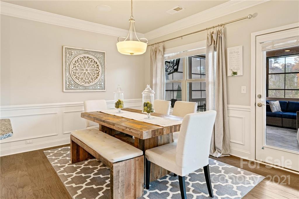 16024 Loch Raven Road Huntersville, NC 28078 - Photo 13 of 45 a dining room with wooden floor and a chandelier