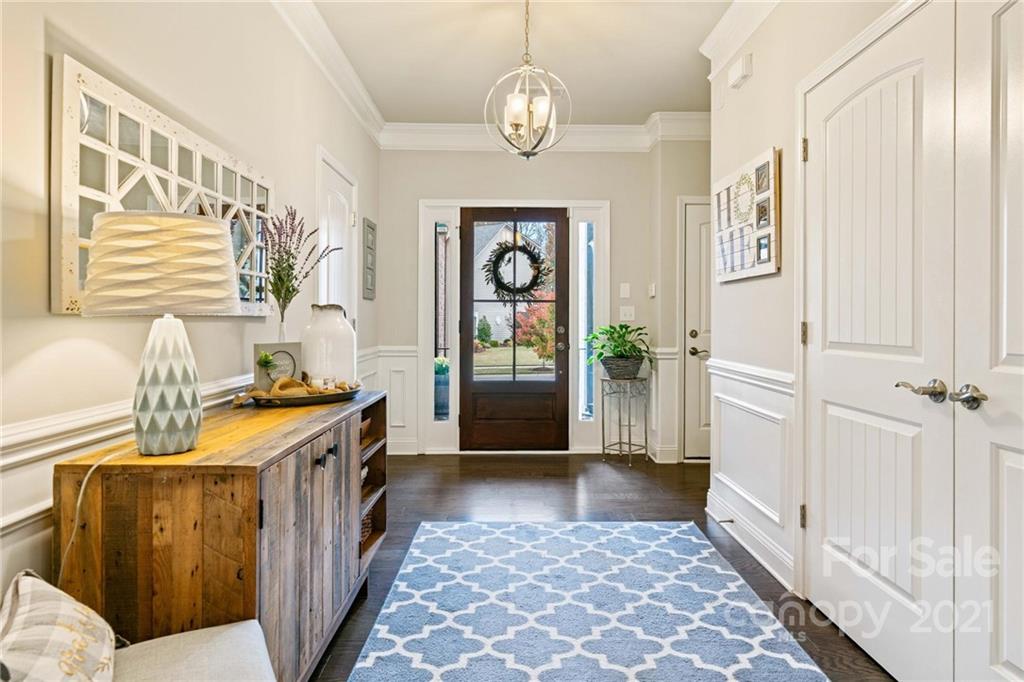 16024 Loch Raven Road Huntersville, NC 28078 - Photo 3 of 45 a view of a hallway to a livingroom with wooden floor and furniture