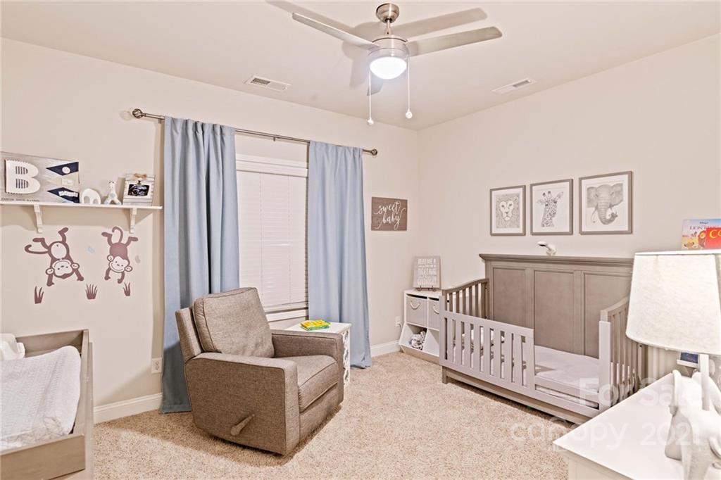 16024 Loch Raven Road Huntersville, NC 28078 - Photo 23 of 45 a living room with furniture and a baby crib