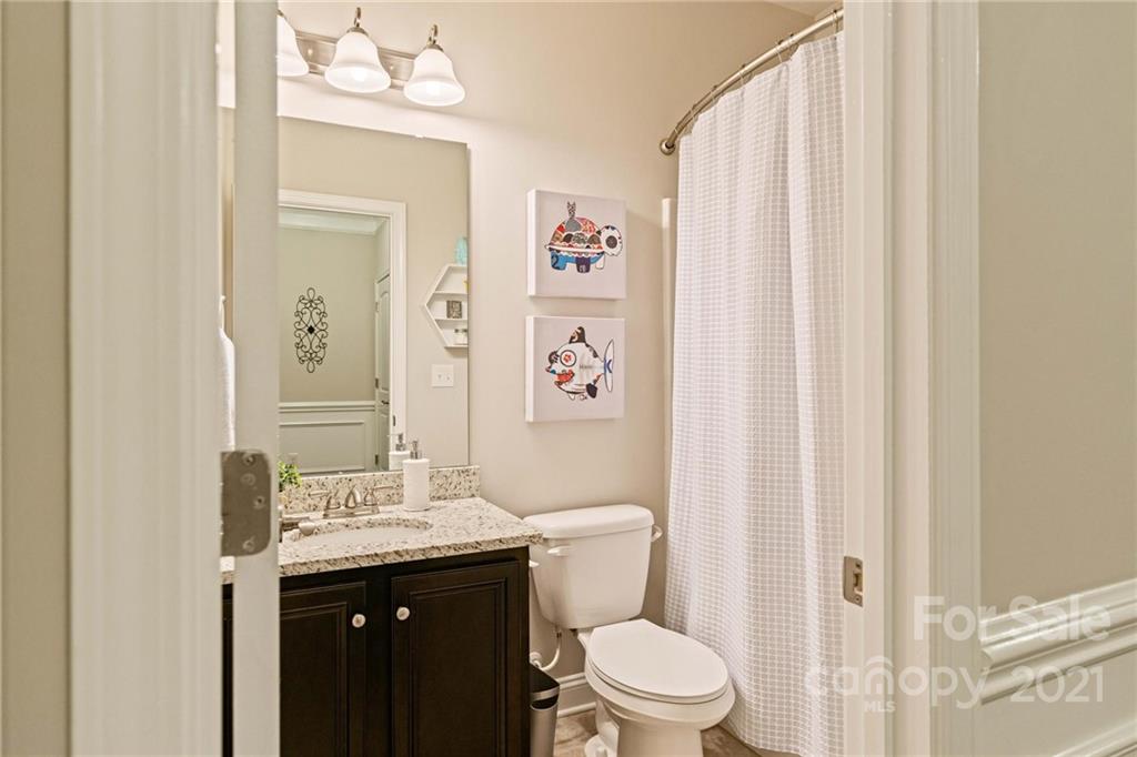 16024 Loch Raven Road Huntersville, NC 28078 - Photo 24 of 45 a bathroom with a sink a toilet and shower curtain