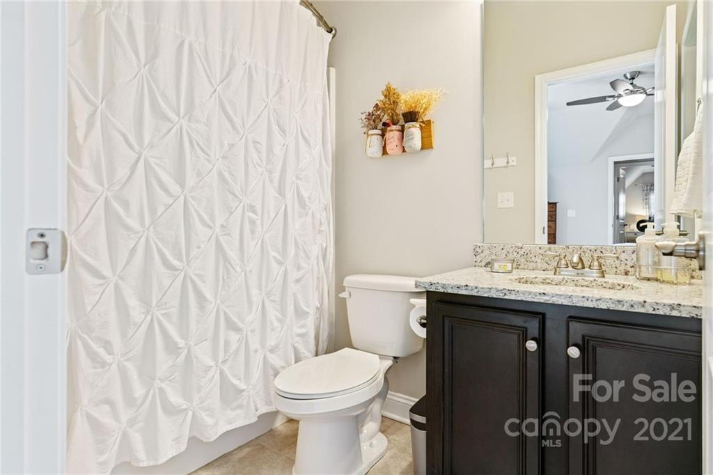 16024 Loch Raven Road Huntersville, NC 28078 - Photo 28 of 45 a bathroom with a granite countertop sink and a toilet