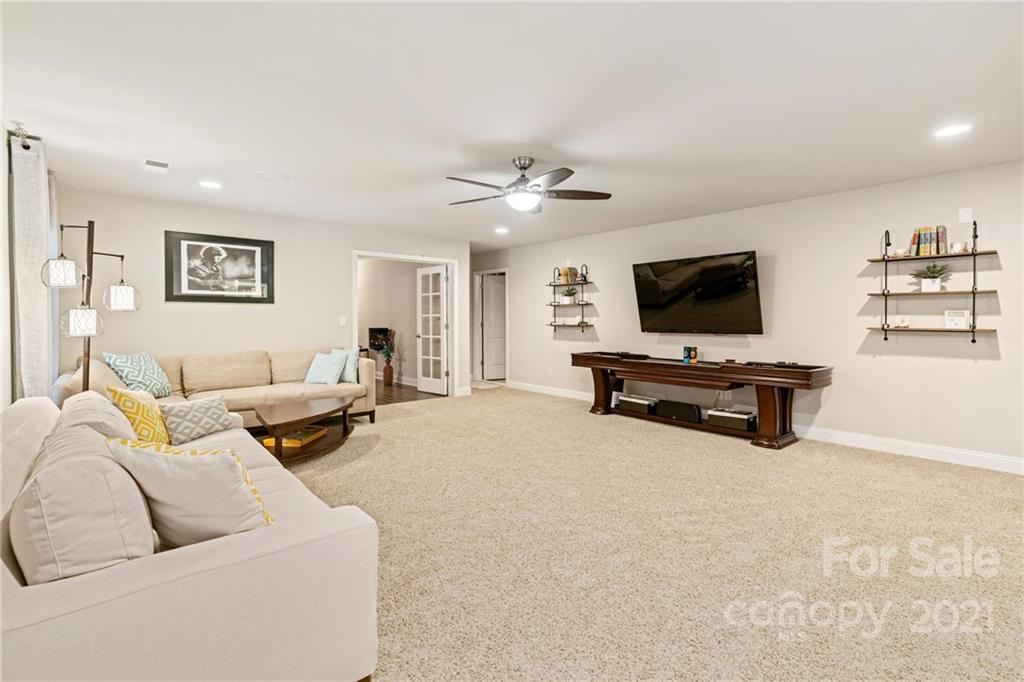 16024 Loch Raven Road Huntersville, NC 28078 - Photo 30 of 45 a living room with furniture and a flat screen tv