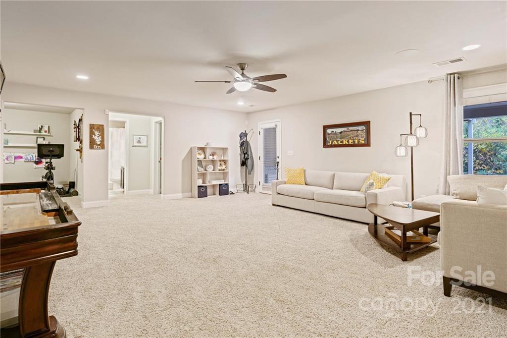16024 Loch Raven Road Huntersville, NC 28078 - Photo 32 of 45 a living room with furniture and a flat screen tv