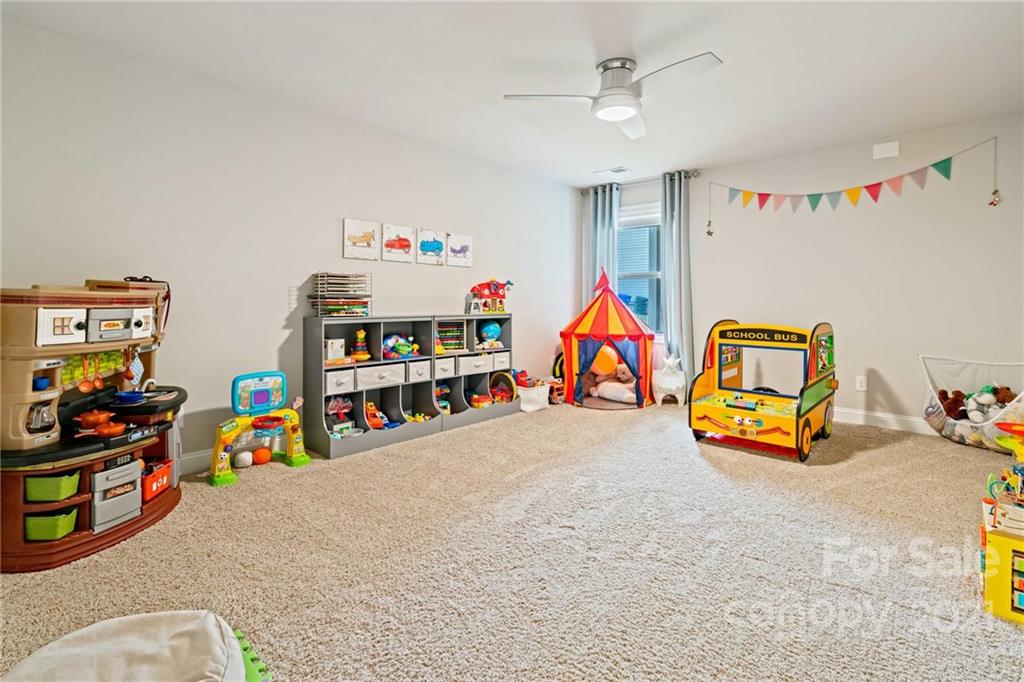 16024 Loch Raven Road Huntersville, NC 28078 - Photo 33 of 45 a children room with toys and a couch