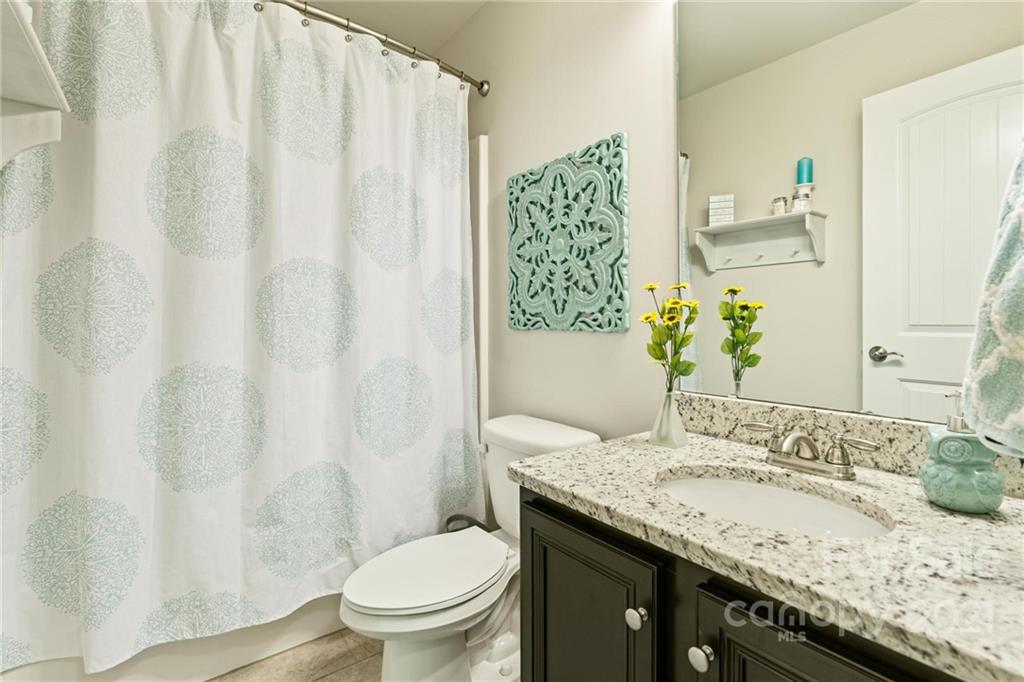 16024 Loch Raven Road Huntersville, NC 28078 - Photo 35 of 45 a bathroom with a granite countertop sink and a mirror
