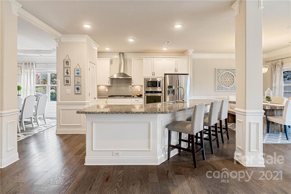 16024 Loch Raven Road Huntersville, NC 28078 - Photo 5 of 45 a large kitchen with cabinets chairs and wooden floor