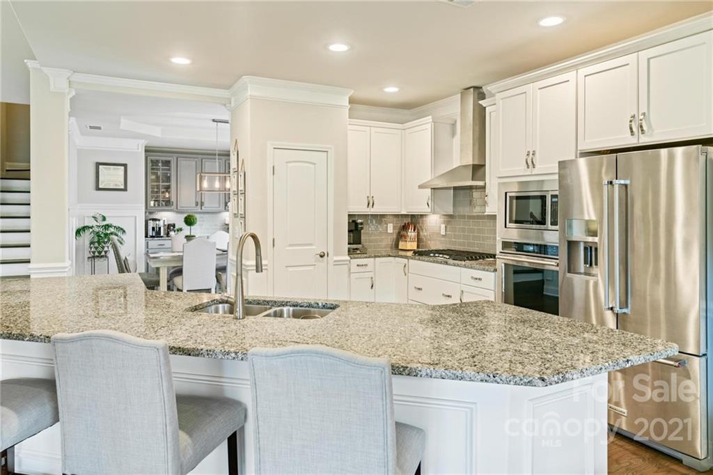 16024 Loch Raven Road Huntersville, NC 28078 - Photo 6 of 45 a kitchen with stainless steel appliances granite countertop a sink refrigerator and cabinets