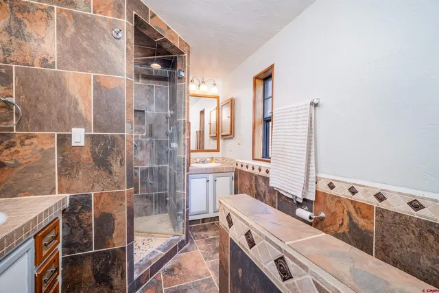 a bathroom with a mirror and a shower