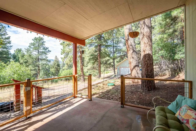 a view of a porch with furniture and a yard