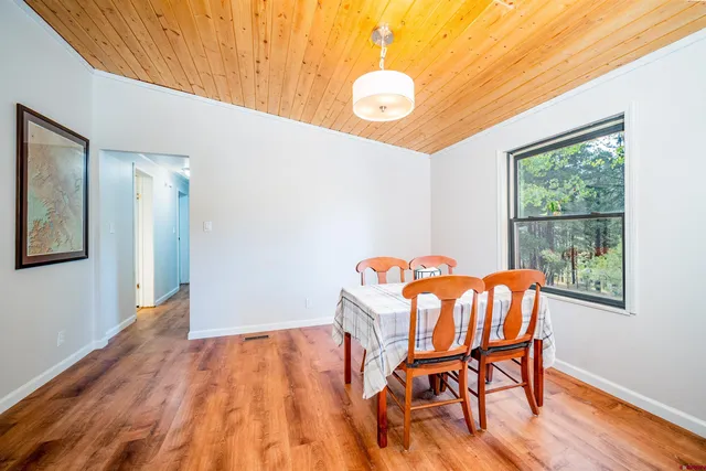 a view of a room with furniture and wooden floor