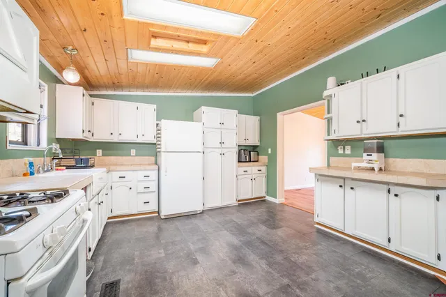 a kitchen with cabinets appliances a sink and a stove