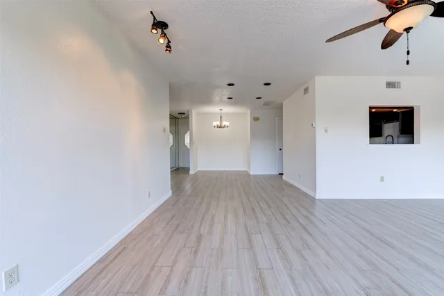a view of a room with wooden floor