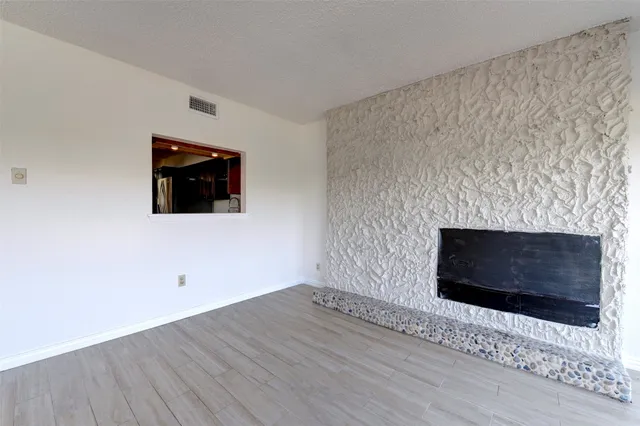 a living room with a fireplace and a flat screen tv