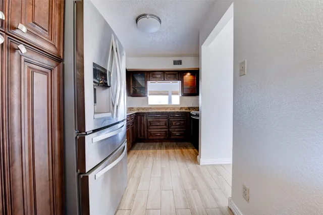 a kitchen with stainless steel appliances a refrigerator and a stove