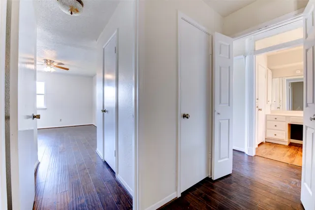 a view of a hallway with wooden floor windows and livingroom