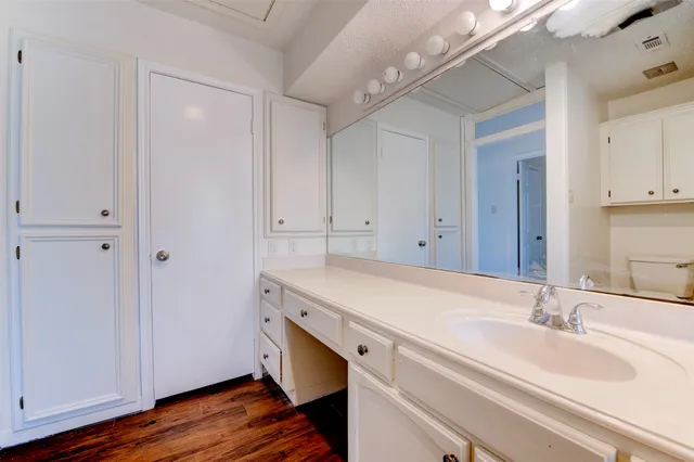 a room with a sink vanity and mirror