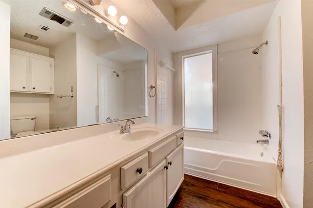 a bathroom with a bathtub and a sink