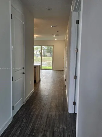 a kitchen with refrigerator and window