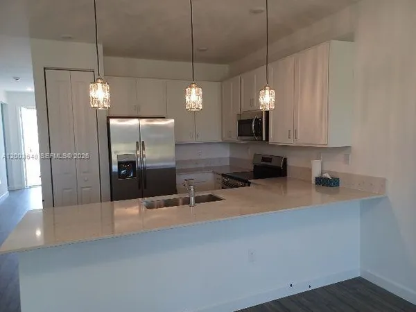 a kitchen with a refrigerator sink and microwave