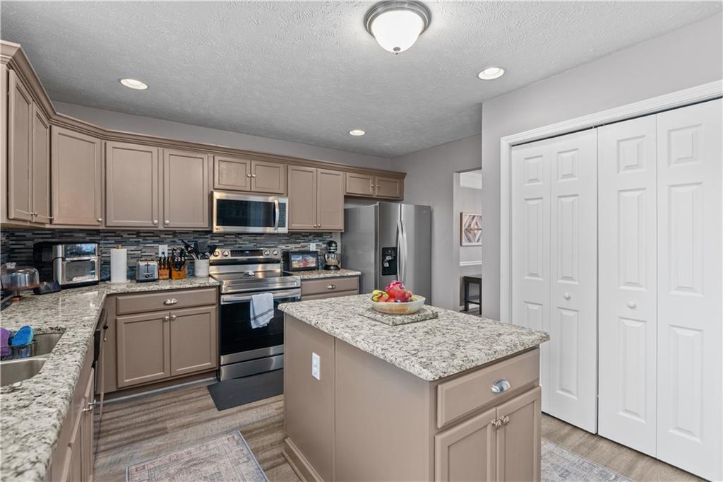 421 Colt Circle Clinton, PA 15026 - Photo 11 of 32 a kitchen with kitchen island granite countertop stainless steel appliances a stove sink microwave and cabinets