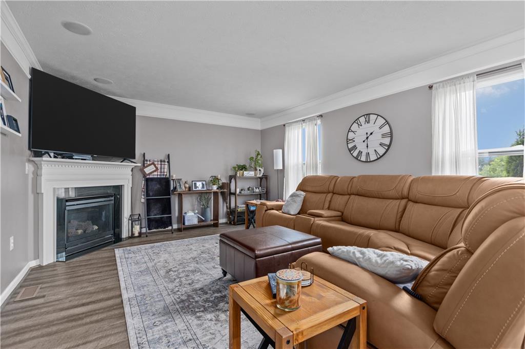 421 Colt Circle Clinton, PA 15026 - Photo 14 of 32 a living room with furniture a flat screen tv and a fireplace