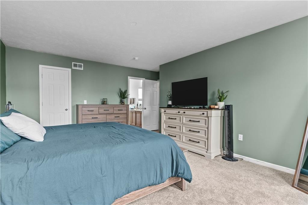 421 Colt Circle Clinton, PA 15026 - Photo 19 of 32 a bedroom with a bed and a flat screen tv