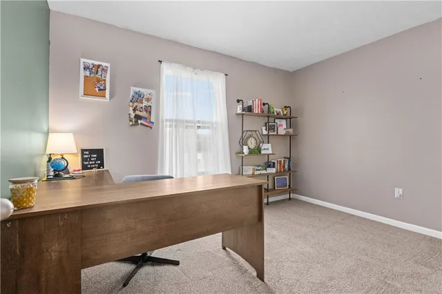 a room with a desk and book shelf