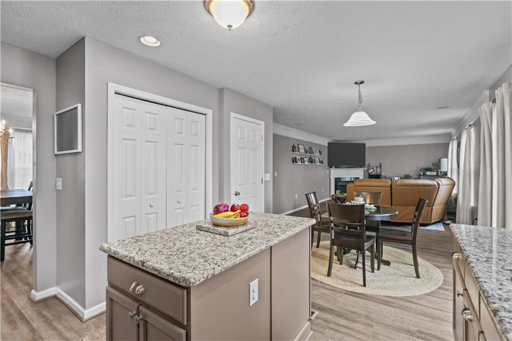 421 Colt Circle Clinton, PA 15026 - Photo 10 of 32 a kitchen with stainless steel appliances granite countertop a stove top oven a dining table and chairs with wooden floor