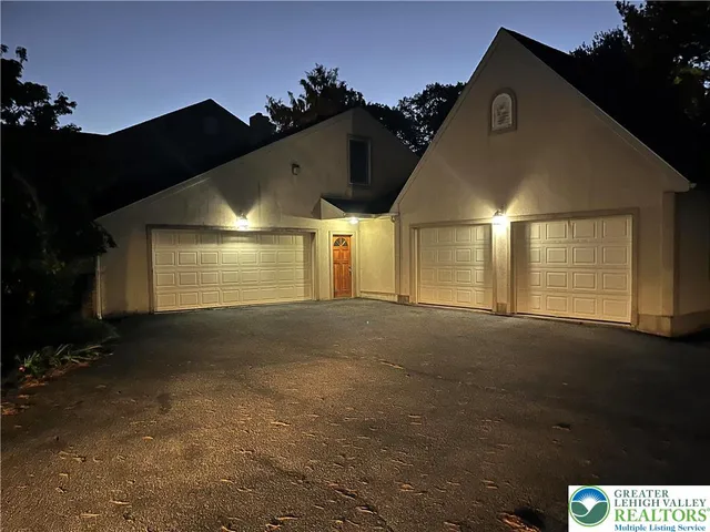 a kitchen with stainless steel appliances granite countertop a stove a sink and white cabinets