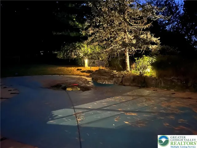 a kitchen with stainless steel appliances granite countertop a refrigerator a sink dishwasher a stove and white cabinets with wooden floor