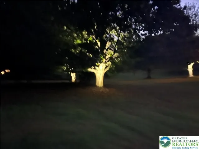 a kitchen with granite countertop a sink a stove and refrigerator