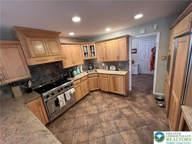 a living room with furniture a flat screen tv and large window
